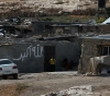 The occupation beats a civilian during the demolition of his house in Masafer Yatta