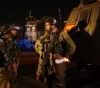 Occupation arrests 14 Palestinians, including a woman from Jerusalem