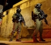 Occupation arrests 12 Palestinians from the West Bank