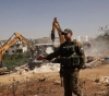 The occupation demolishes houses and bulldozes land in favor of a settlement street in Yatta