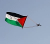 The Palestinian flag flutters in the sky of Bab al-Amud and the Old City