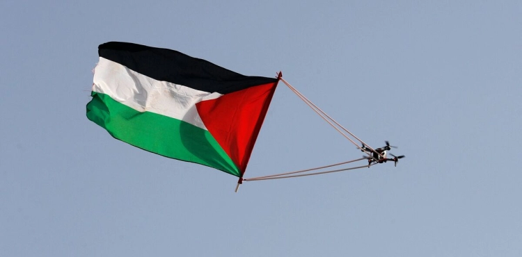 The Palestinian flag flutters in the sky of Bab al-Amud and the Old City