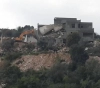 Israeli bulldozers demolish a building and a house under construction in Wadi Ara