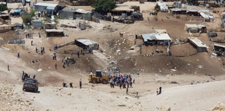 Protesters confront settlers who stormed the village of al-Khan al-Ahmar, threatened with demolition