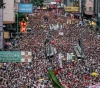 Thousands march in Hong Kong to protest police wounding student