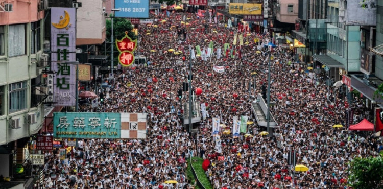 Thousands march in Hong Kong to protest police wounding student