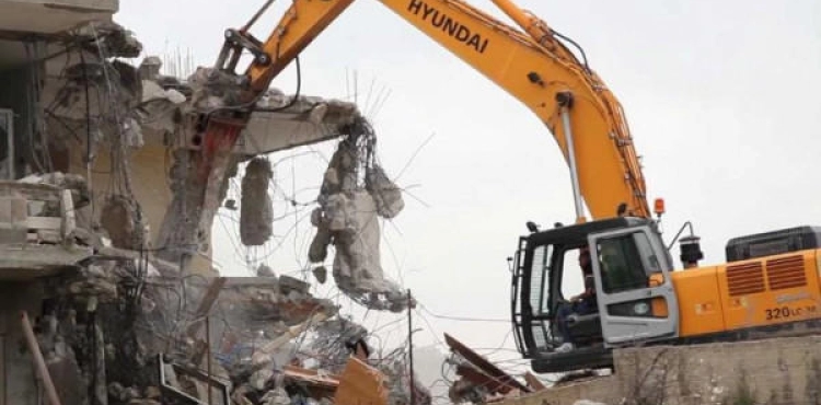 Israeli forces demolish a house in the industrial zone north of occupied Jerusalem