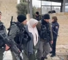 The occupation forces a woman in Bab Al-Amoud