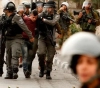 The occupation forces arrest two young men and boys, and raids houses in Ya`bad