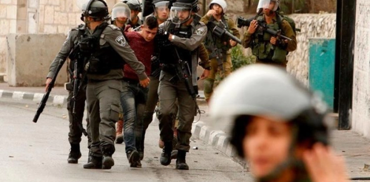 The occupation forces arrest two young men and boys, and raids houses in Ya`bad