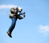 A man is flying in the air using a jetpack in Los Angeles