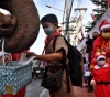 Elephants in Santa Claus uniform distribute masks at a Thai school