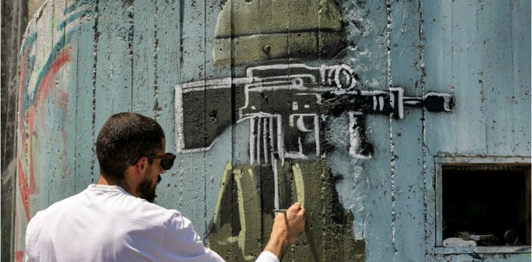 Sebatin.. An artist denounces the occupation through graffiti on the apartheid wall