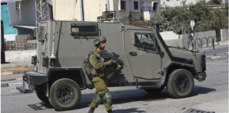 The occupation closes the iron gate at the entrance to the village of Haris